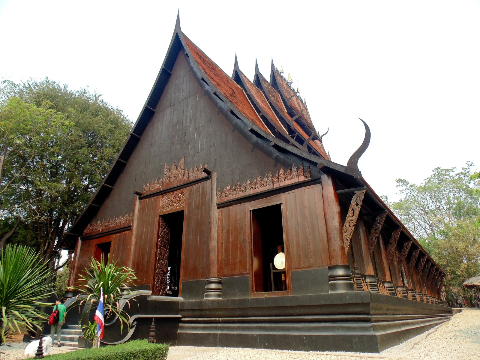 The Black House's dark teak pavilion with curling naga-horn roof finials, Chiang Rai