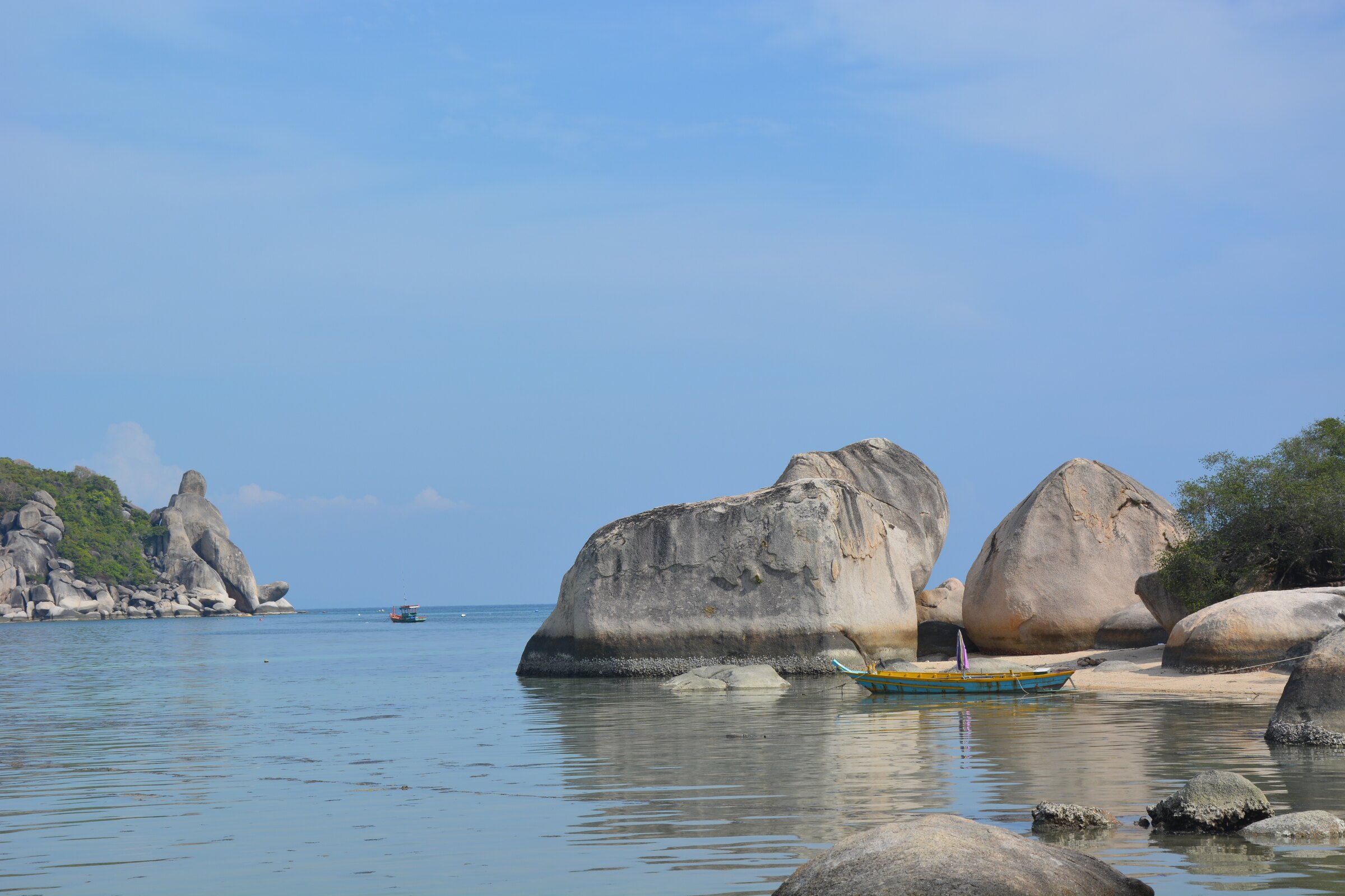 Granite boulders standing in the still water of Chalok Baan Kao bay, Koh Tao