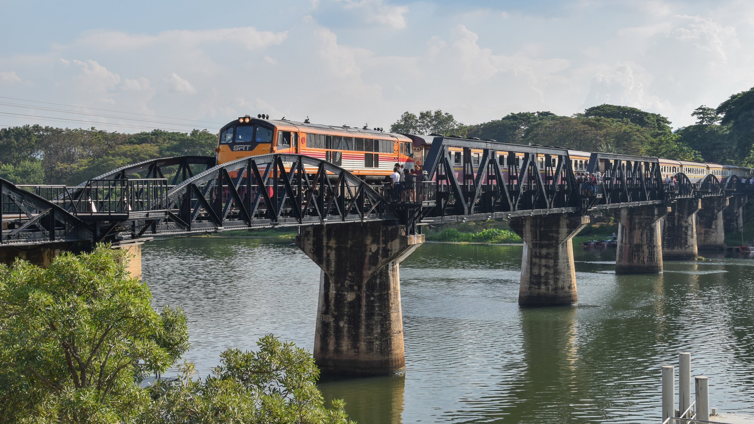 A train crossing the iron bridge over the River Kwai at Kanchanaburi