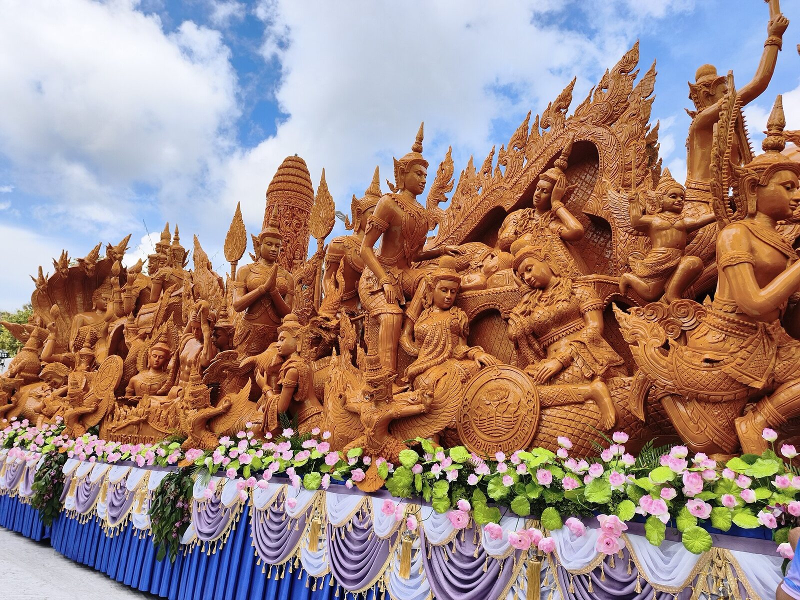 An intricately carved wax candle float of mythological figures at the Ubon candle festival