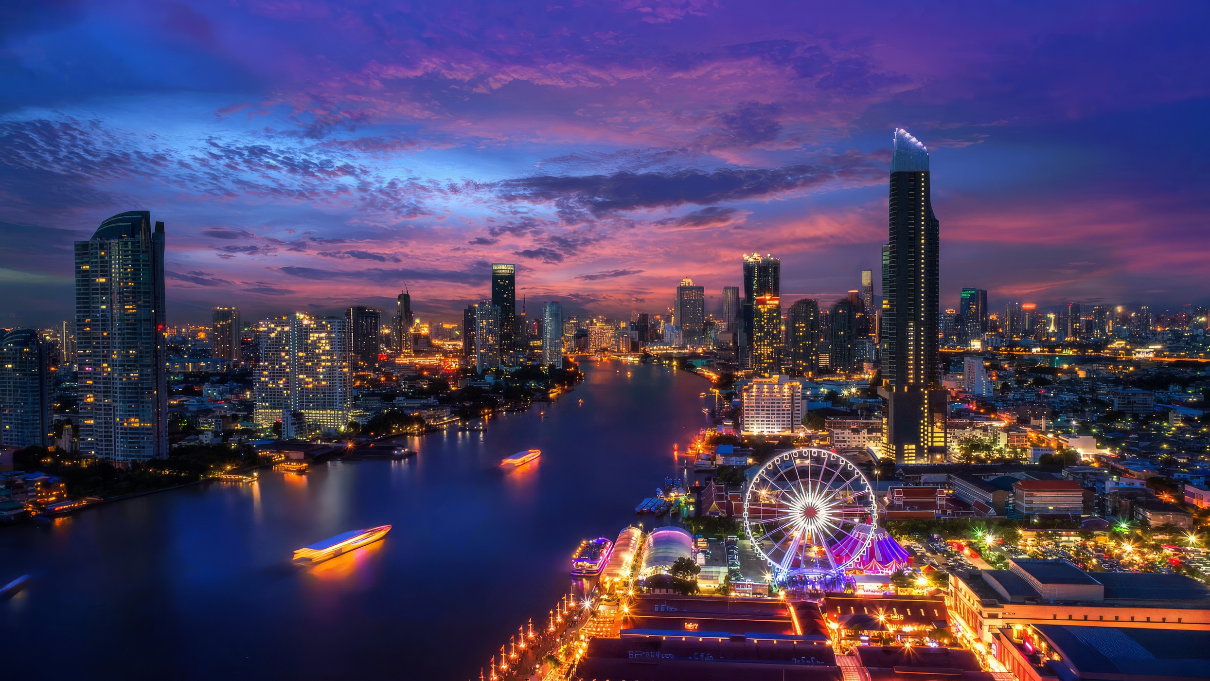The Bangkok skyline and Chao Phraya at twilight, Asiatique's wheel lit below