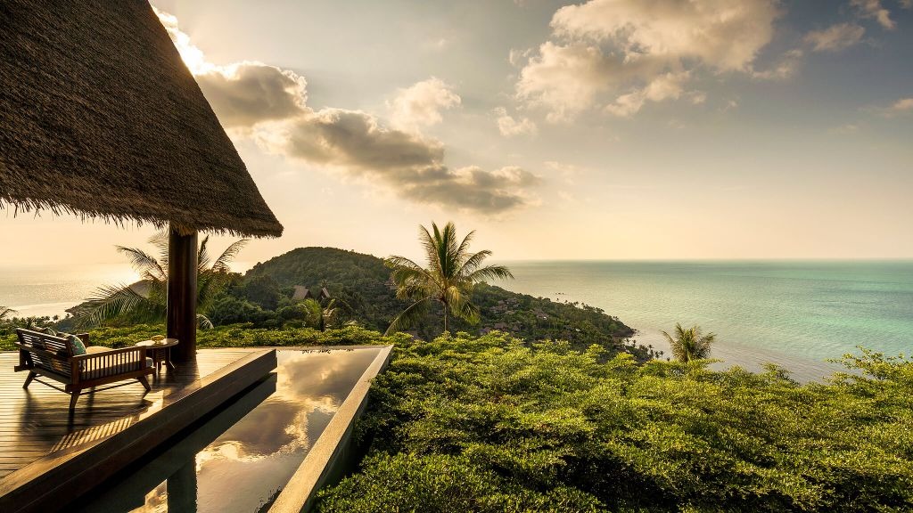 A hillside pool deck above the Gulf at sunset