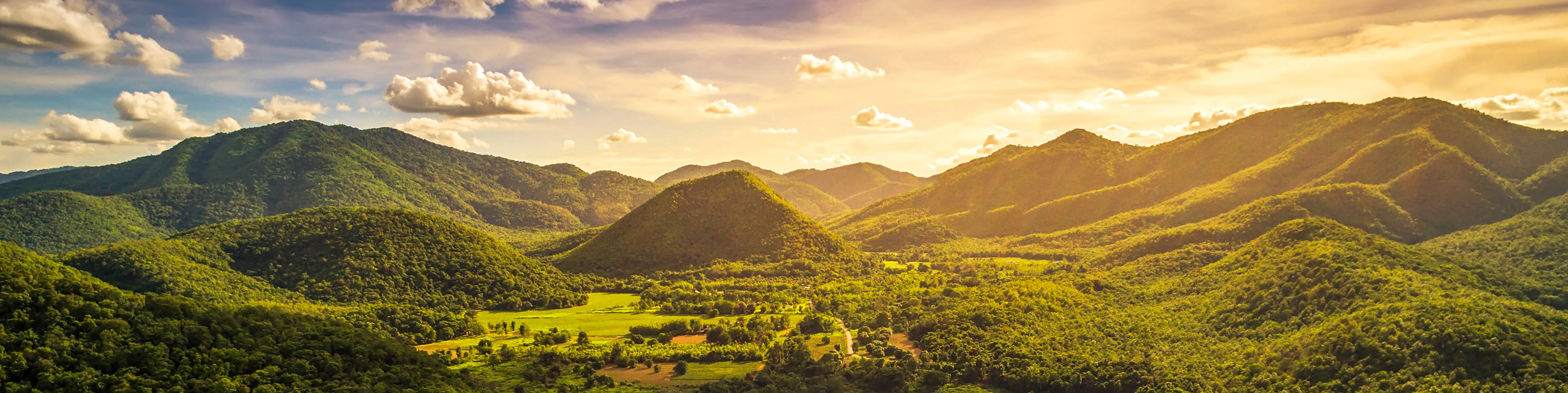 Rolling green mountains in golden light, northern Thailand