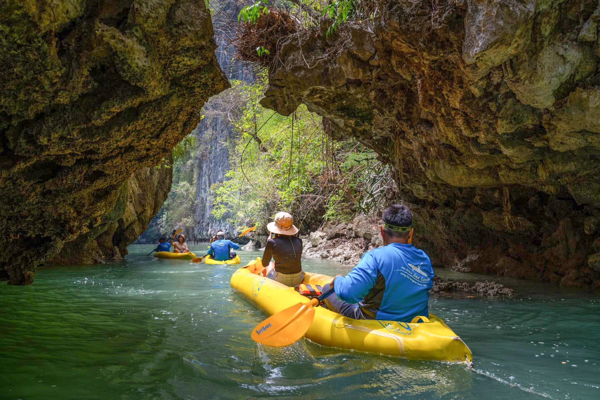 Kayaking through a hidden hong cave in Phang Nga Bay before the day's tour boats arrive