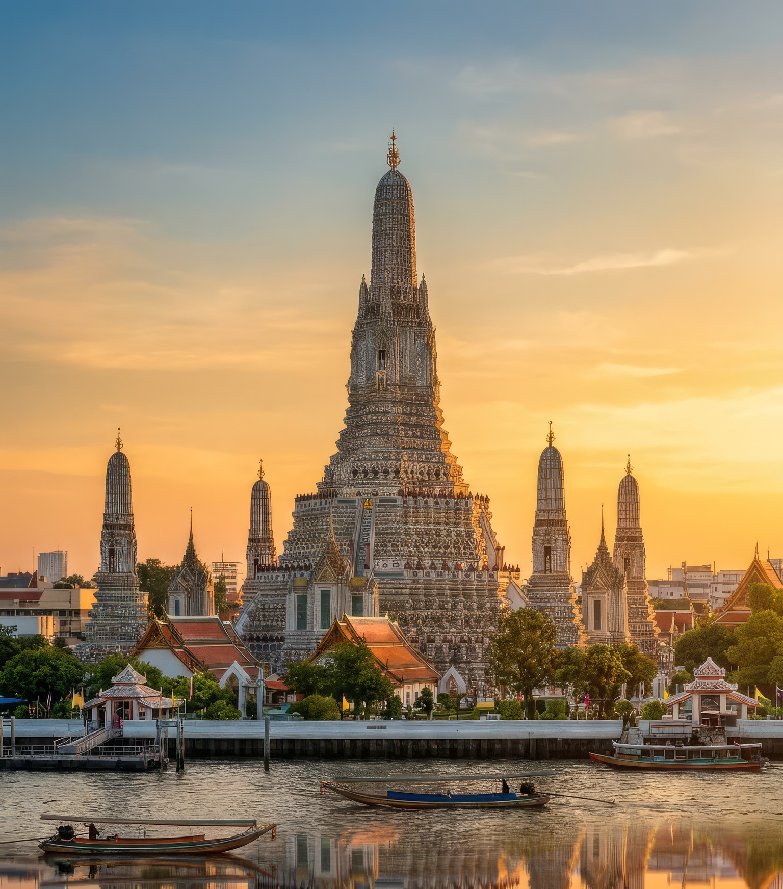 Wat Arun above the Chao Phraya at sunset, longtail boats on the river