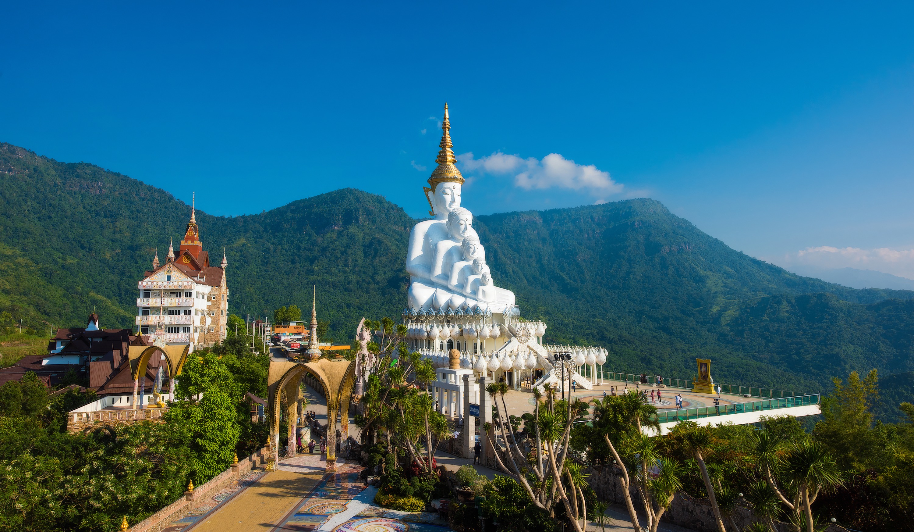 The tiered white Buddhas of Wat Pha Sorn Kaew above the Khao Kho hills
