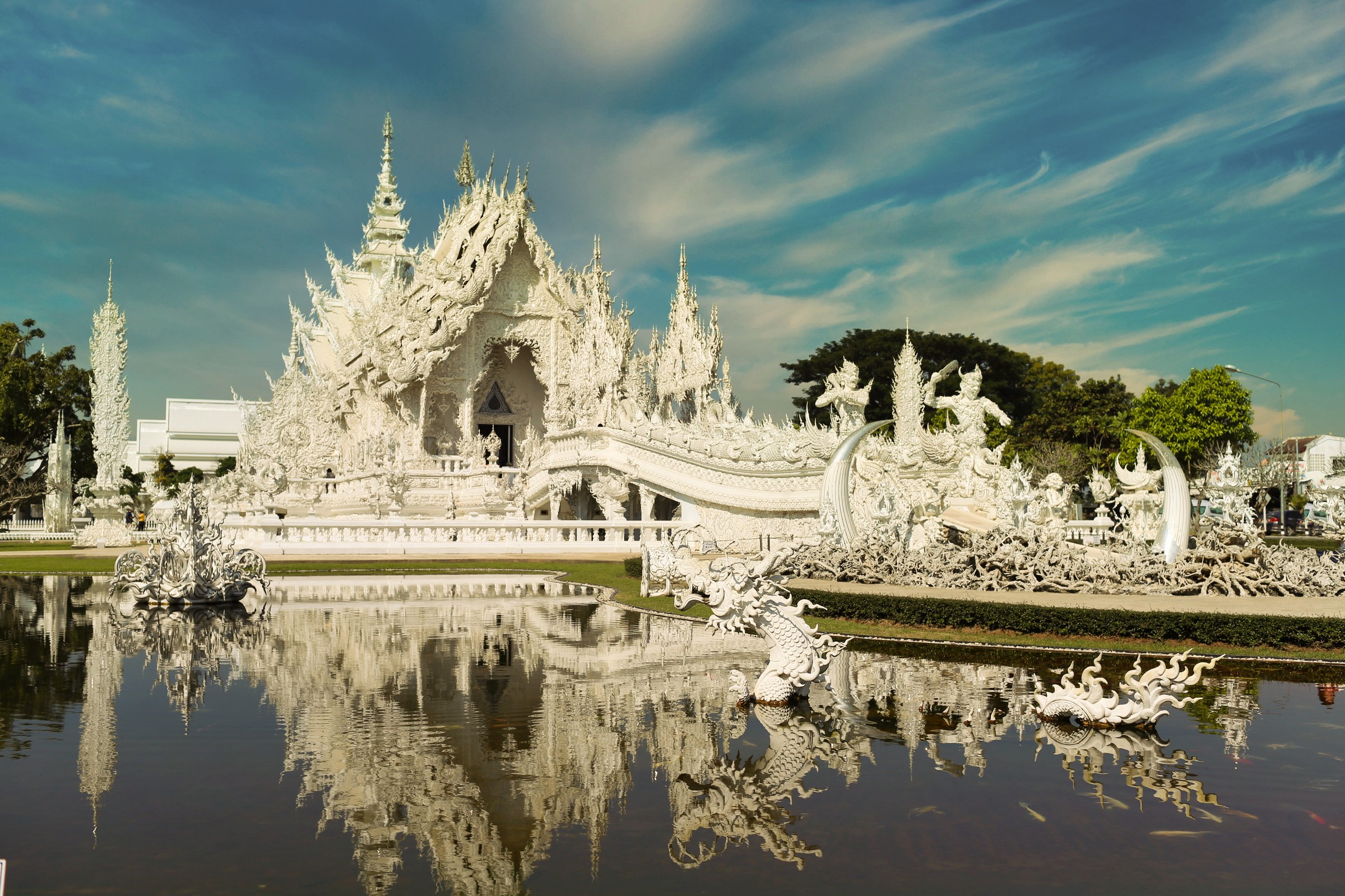 Wat Rong Khun, the White Temple, mirrored in its reflecting pool