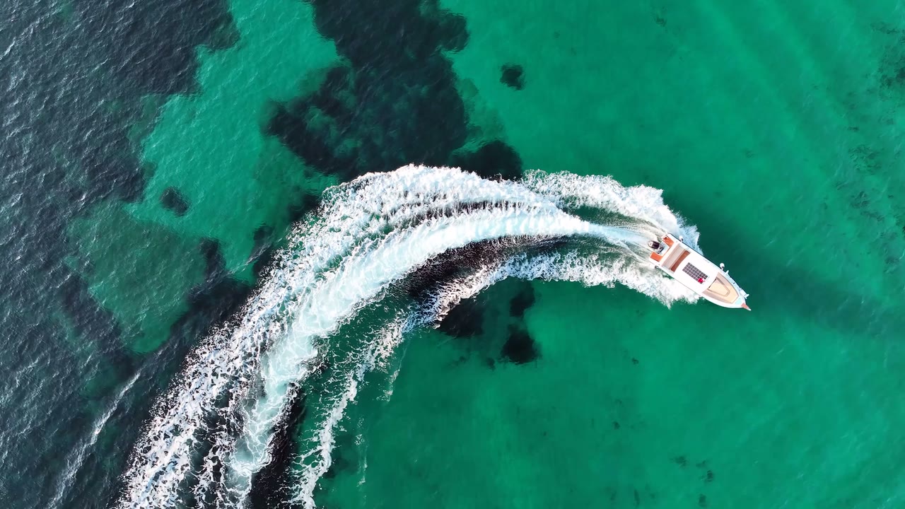 A private motor yacht crossing the emerald waters of southern Thailand